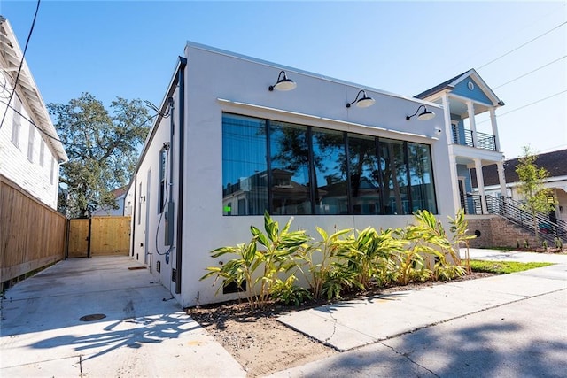 424 S Lopez St, New Orleans, LA 70119 - view of front of property featuring stucco siding and a balcony