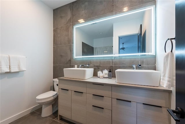 424 S Lopez St, New Orleans, LA 70119 - full bathroom featuring tile walls, double vanity, tile patterned floors, and tasteful backsplash