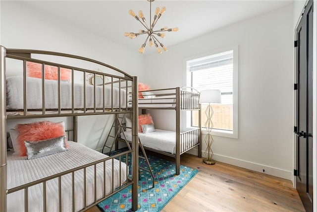 424 S Lopez St, New Orleans, LA 70119 - bedroom with a chandelier and wood finished floors