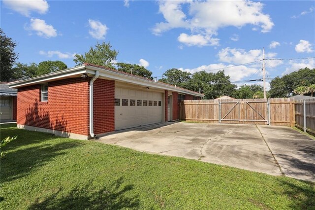920 Hesper Ave, Metairie, LA 70005 - view of side of home with brick siding, a gate, and a garage