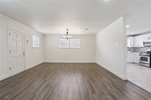 920 Hesper Ave, Metairie, LA 70005 - unfurnished living room with crown molding, wood finished floors, a chandelier, and recessed lighting