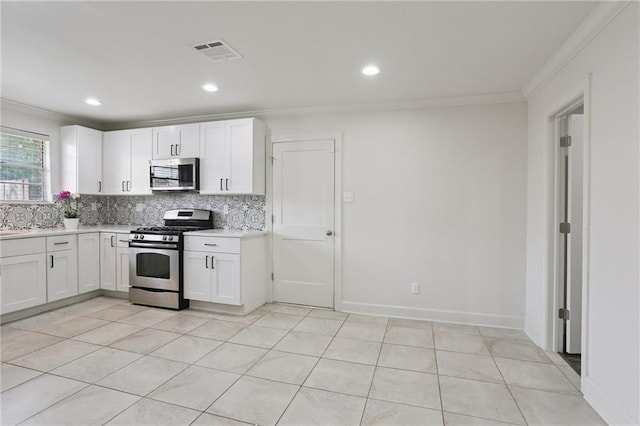 920 Hesper Ave, Metairie, LA 70005 - kitchen featuring stainless steel appliances, crown molding, decorative backsplash, light countertops, and white cabinetry