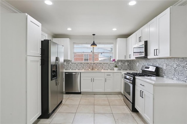 920 Hesper Ave, Metairie, LA 70005 - kitchen with stainless steel appliances, light countertops, white cabinets, tasteful backsplash, and light tile patterned floors