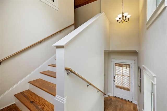 921 Carriage Way, Baton Rouge, LA 70808 - stairway with a chandelier, a towering ceiling, and wood finished floors