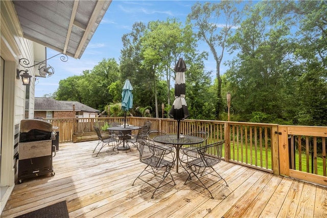 921 Carriage Way, Baton Rouge, LA 70808 - wooden deck with outdoor dining space and view of scattered trees