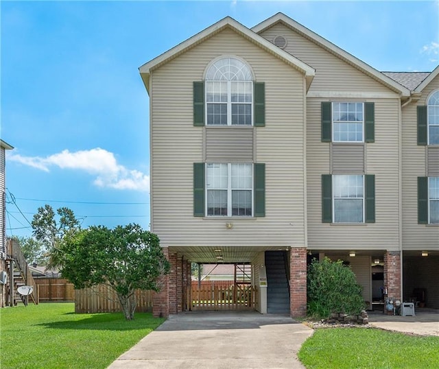 41 Brandon Hall Dr Unit A, Destrehan, LA 70047 - view of front of home with a carport, concrete driveway, and brick siding