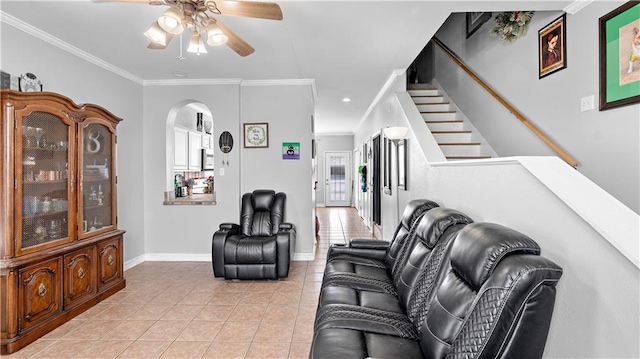 41 Brandon Hall Dr Unit A, Destrehan, LA 70047 - living room featuring a ceiling fan, light tile patterned flooring, arched walkways, ornamental molding, and stairway