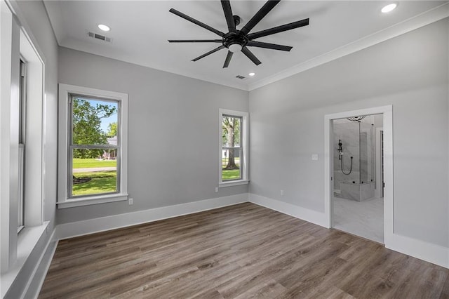 163 S 7th St, Ponchatoula, LA 70454 - unfurnished bedroom with multiple windows, wood finished floors, crown molding, ensuite bath, and recessed lighting