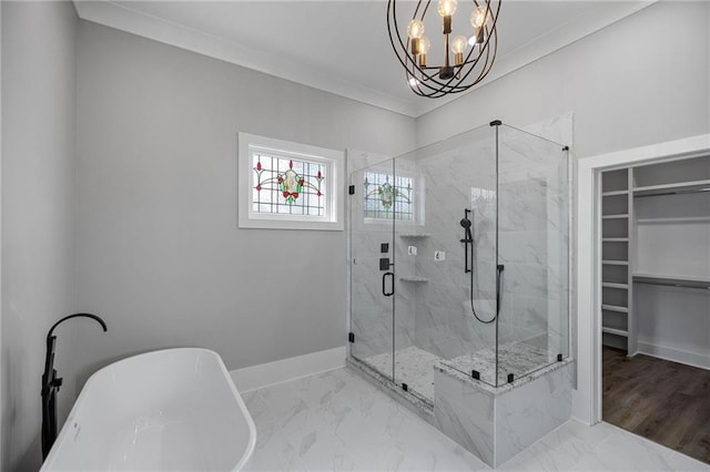 163 S 7th St, Ponchatoula, LA 70454 - bathroom featuring a freestanding bath, a marble finish shower, a chandelier, a walk in closet, and ornamental molding