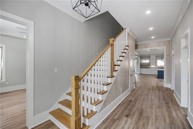 163 S 7th St, Ponchatoula, LA 70454 - staircase featuring wood finished floors, a chandelier, ornamental molding, and recessed lighting
