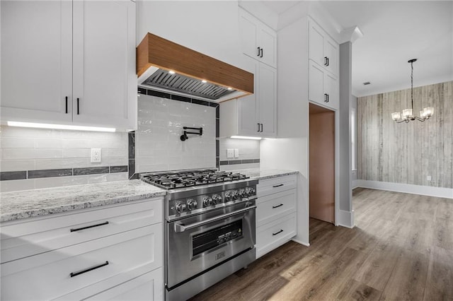 163 S 7th St, Ponchatoula, LA 70454 - kitchen featuring high end stainless steel range oven, custom exhaust hood, a chandelier, and white cabinets
