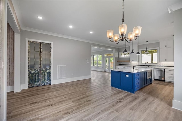 163 S 7th St, Ponchatoula, LA 70454 - kitchen featuring dishwasher, blue cabinets, a chandelier, white cabinets, and plenty of natural light
