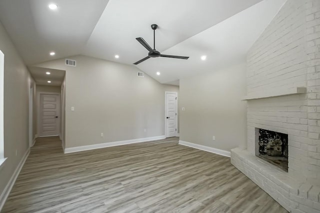 217 Chess Dr, Slidell, LA 70458 - unfurnished living room featuring vaulted ceiling, ceiling fan, wood finished floors, a fireplace, and recessed lighting