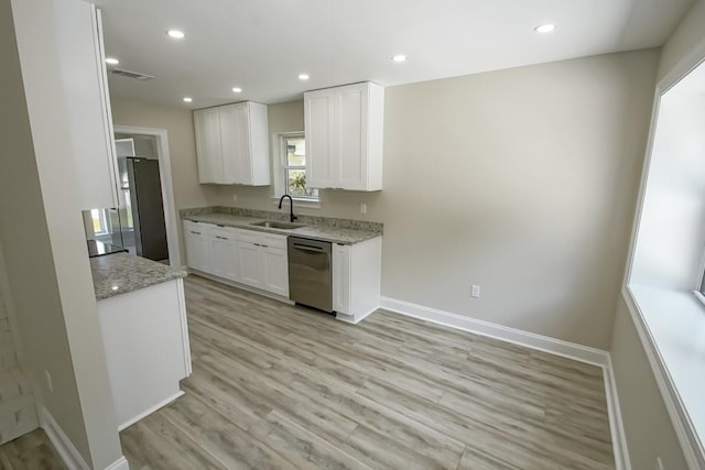 217 Chess Dr, Slidell, LA 70458 - kitchen featuring stainless steel appliances, white cabinets, light wood-style floors, light stone countertops, and recessed lighting