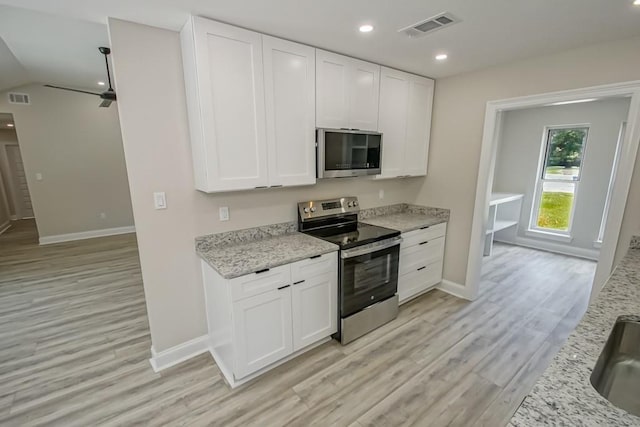 217 Chess Dr, Slidell, LA 70458 - kitchen featuring stainless steel appliances, light wood-type flooring, white cabinetry, light stone countertops, and recessed lighting