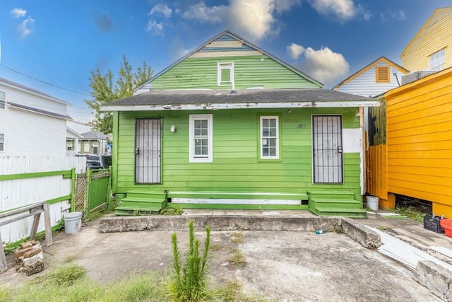 1345 Saint Anthony St, New Orleans, LA 70116 - back of property featuring a patio, entry steps, and a shingled roof
