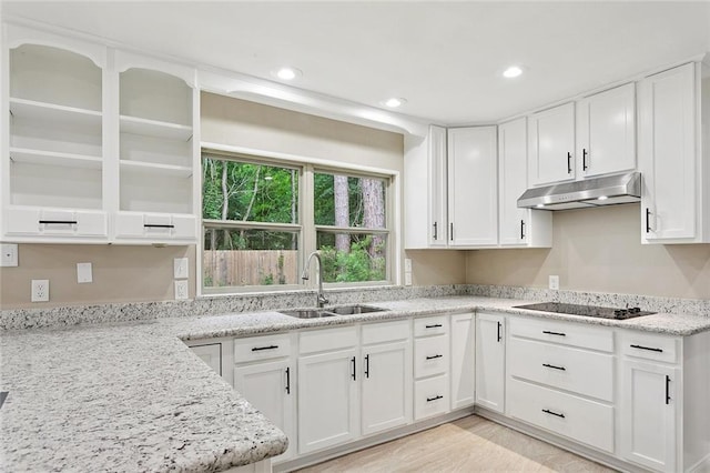 11 Karen Dr, Covington, LA 70433 - kitchen with under cabinet range hood, black electric cooktop, white cabinetry, light stone countertops, and recessed lighting