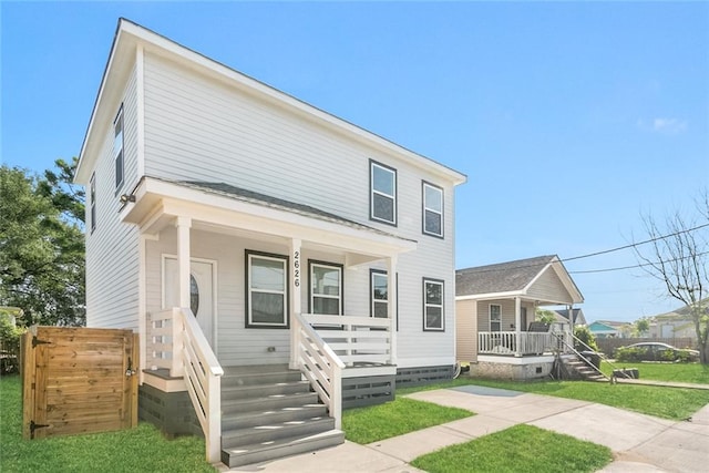 2626 N Dorgenois St, New Orleans, LA 70117 - view of front of house featuring covered porch, a front lawn, and crawl space