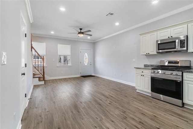 2626 N Dorgenois St, New Orleans, LA 70117 - kitchen featuring appliances with stainless steel finishes, a ceiling fan, ornamental molding, recessed lighting, and light wood finished floors