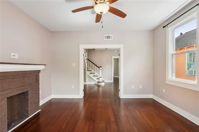 2907-09 Paris Ave, New Orleans, LA 70119 - unfurnished living room with stairway, wood finished floors, a ceiling fan, and a fireplace