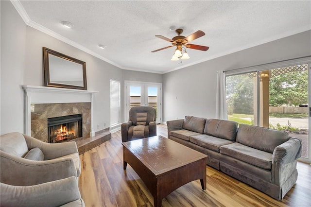 109 Topsl Dr Unit 109, Mandeville, LA 70448 - living room featuring plenty of natural light, a ceiling fan, crown molding, a textured ceiling, and wood finished floors