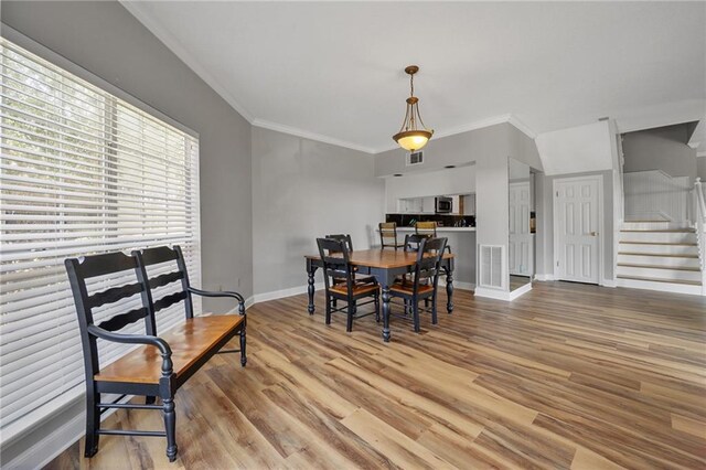 109 Topsl Dr Unit 109, Mandeville, LA 70448 - dining area with crown molding, wood finished floors, and stairway