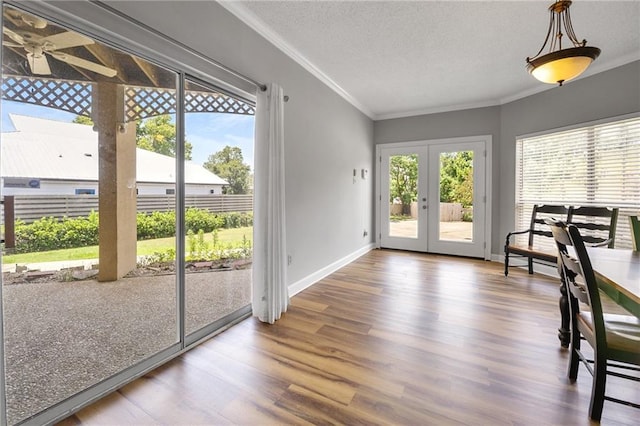 109 Topsl Dr Unit 109, Mandeville, LA 70448 - dining area featuring ornamental molding, wood finished floors, french doors, and a textured ceiling