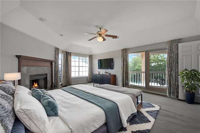 109 Topsl Dr Unit 109, Mandeville, LA 70448 - bedroom with a high end fireplace, a ceiling fan, and wood finished floors