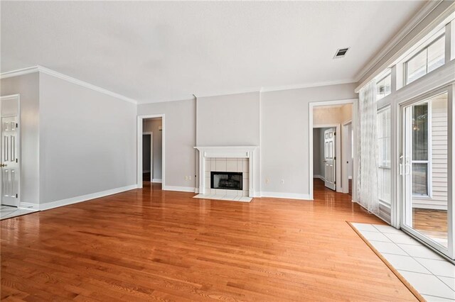 544 Waverly Dr, Slidell, LA 70461 - unfurnished living room featuring light wood-type flooring, crown molding, and a fireplace