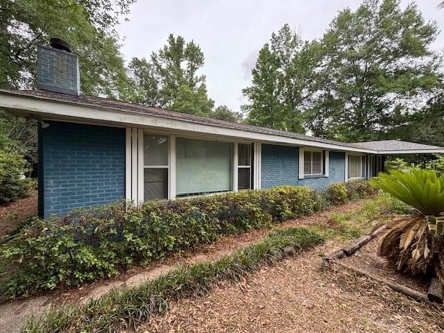19343 9th Ave, Covington, LA 70433 - view of home's exterior featuring brick siding and a chimney