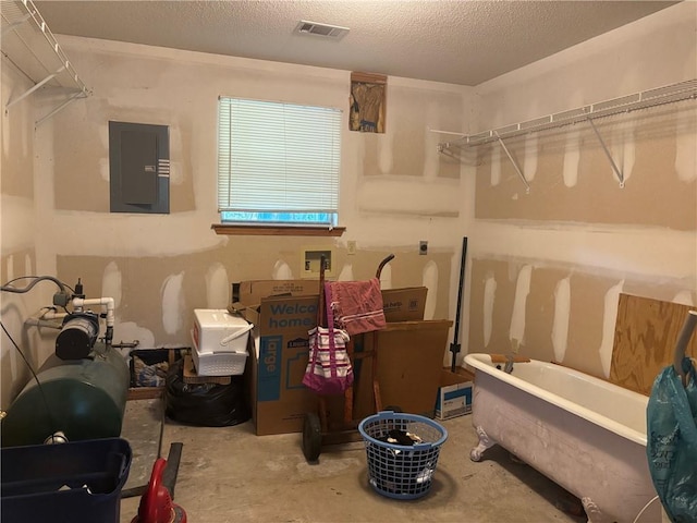 19343 9th Ave, Covington, LA 70433 - full bath with electric panel, a soaking tub, and concrete flooring