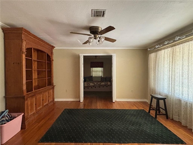 19343 9th Ave, Covington, LA 70433 - interior space with a ceiling fan, wood finished floors, crown molding, and a textured ceiling