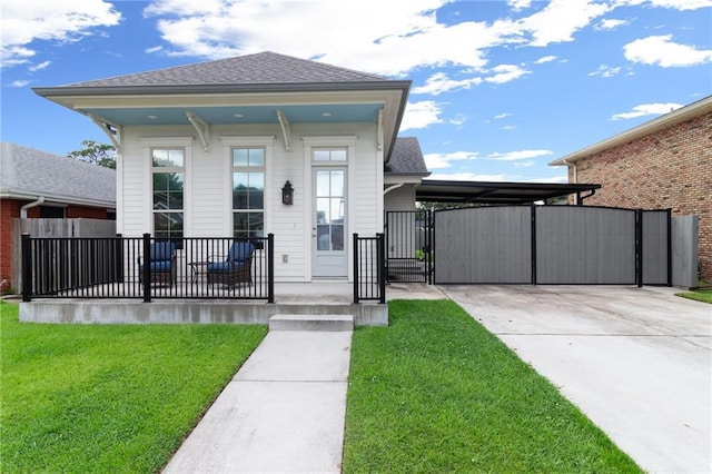 2028 Charles Dr, Chalmette, LA 70043 - view of front of home with a gate, concrete driveway, a carport, and roof with shingles