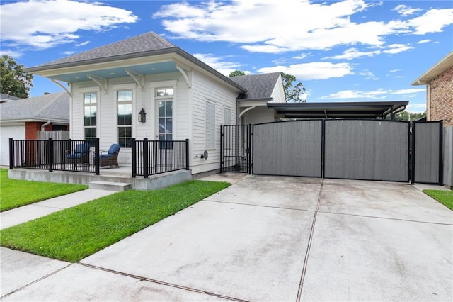 2028 Charles Dr, Chalmette, LA 70043 - view of front of home featuring a gate, a porch, concrete driveway, and a shingled roof