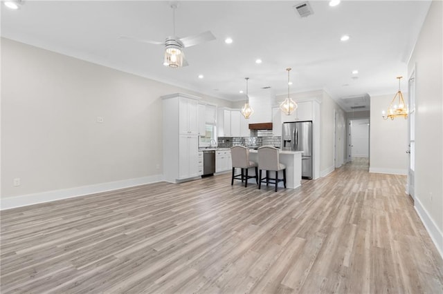 2028 Charles Dr, Chalmette, LA 70043 - kitchen featuring appliances with stainless steel finishes, open floor plan, light countertops, backsplash, and a ceiling fan