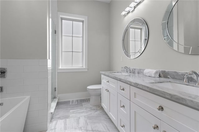 2028 Charles Dr, Chalmette, LA 70043 - full bathroom featuring plenty of natural light, double vanity, a freestanding bath, and marble finish flooring