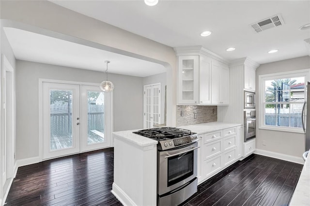 107 Melody Dr, Metairie, LA 70001 - kitchen featuring appliances with stainless steel finishes, french doors, dark wood finished floors, plenty of natural light, and recessed lighting