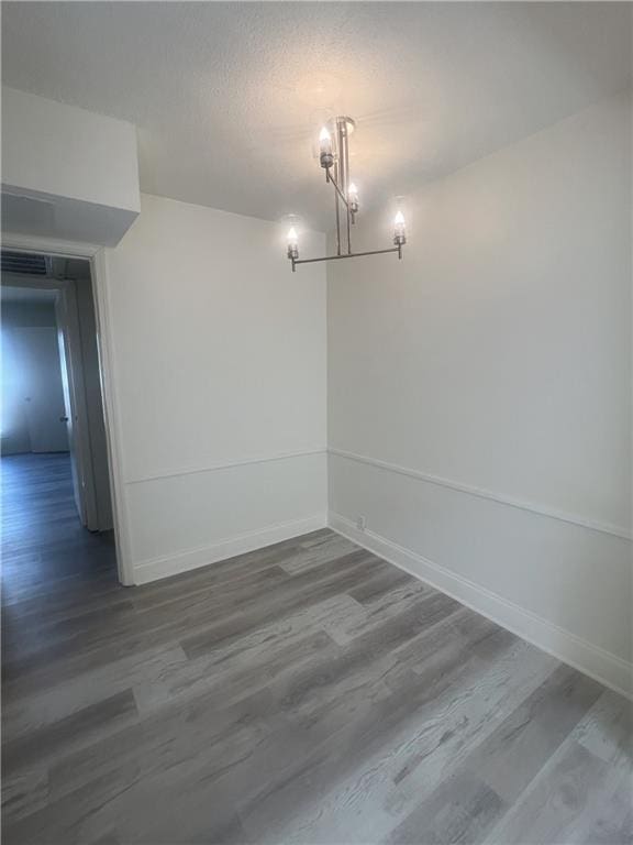 3320 N Arnoult Rd Unit 239, Metairie, LA 70002 - empty room with dark wood-style flooring and a chandelier