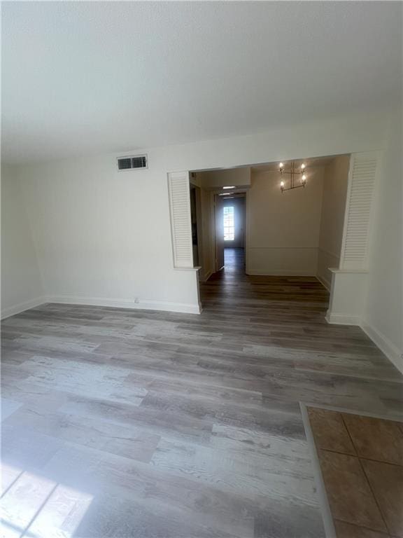 3320 N Arnoult Rd Unit 239, Metairie, LA 70002 - empty room featuring wood finished floors and a chandelier