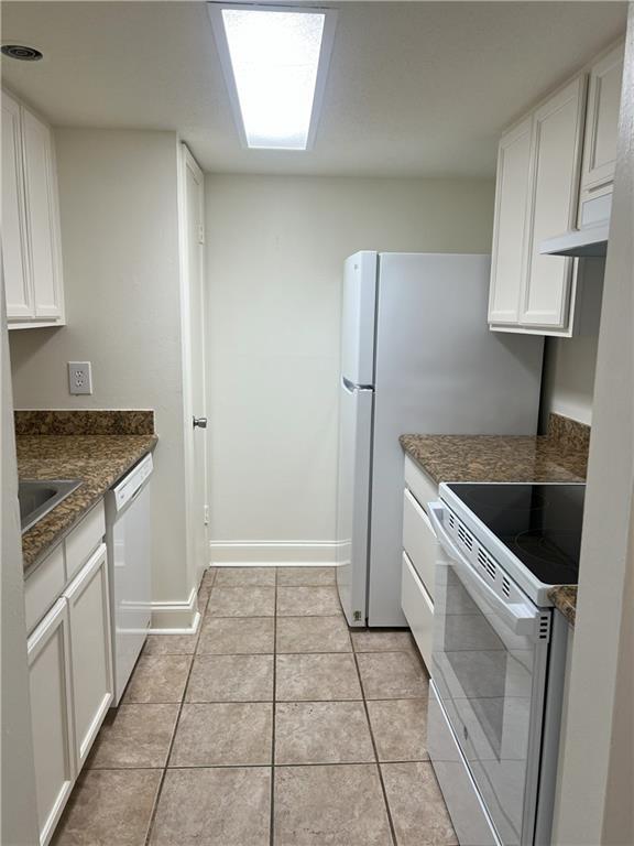 3320 N Arnoult Rd Unit 239, Metairie, LA 70002 - kitchen with white appliances, white cabinets, light tile patterned floors, and under cabinet range hood