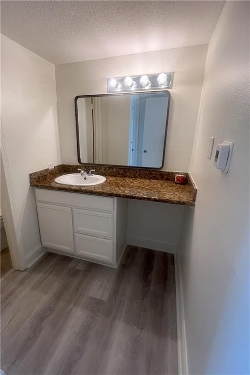 3320 N Arnoult Rd Unit 239, Metairie, LA 70002 - bathroom featuring wood finished floors, a textured ceiling, and vanity