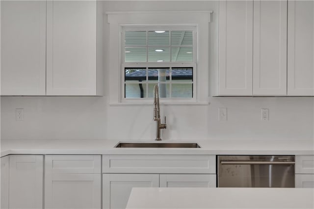 1208 Madison St, Metairie, LA 70001 - kitchen featuring dishwasher, light countertops, and white cabinets