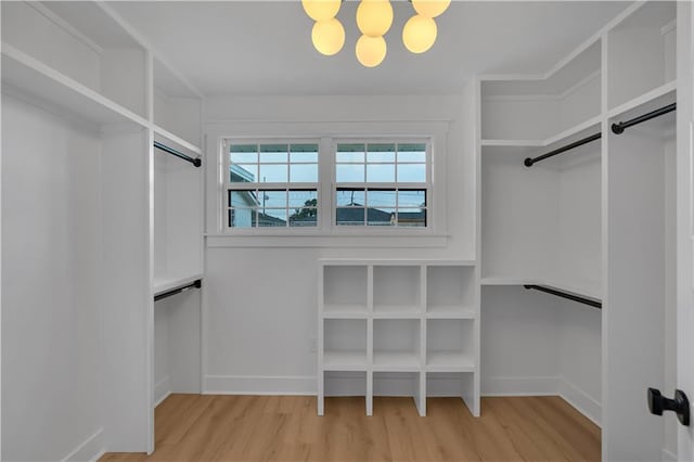 1208 Madison St, Metairie, LA 70001 - walk in closet featuring wood finished floors and a chandelier