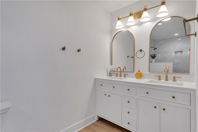 1208 Madison St, Metairie, LA 70001 - bathroom with double vanity, a shower, and wood finished floors