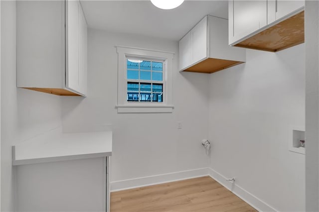 1208 Madison St, Metairie, LA 70001 - laundry room featuring light wood-style floors, cabinet space, gas dryer hookup, and washer hookup