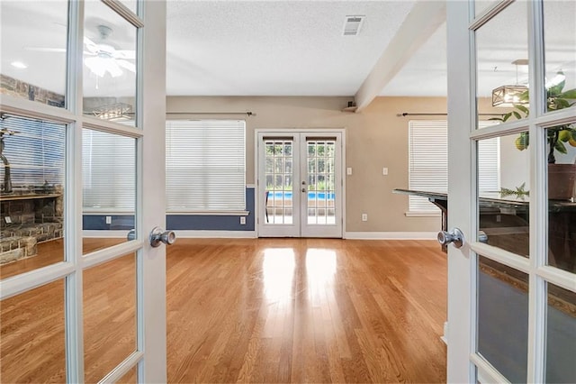 2004 Dierdorff Ct, Slidell, LA 70461 - spare room featuring french doors, wood finished floors, a ceiling fan, and a textured ceiling