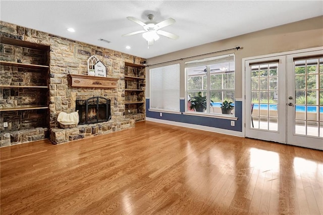 2004 Dierdorff Ct, Slidell, LA 70461 - unfurnished living room featuring a ceiling fan, a fireplace, french doors, wood finished floors, and recessed lighting