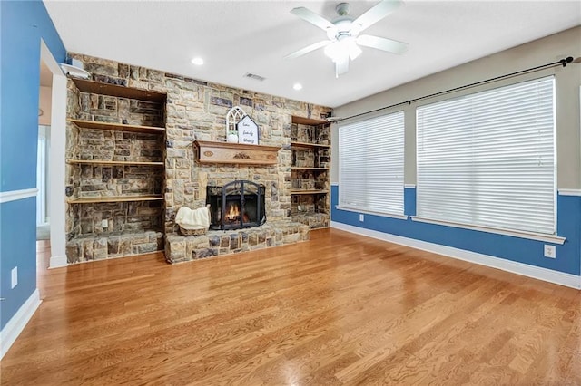 2004 Dierdorff Ct, Slidell, LA 70461 - unfurnished living room featuring a ceiling fan, wood finished floors, and a stone fireplace