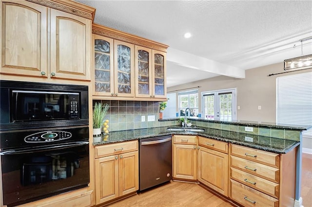 2004 Dierdorff Ct, Slidell, LA 70461 - kitchen with black appliances, a peninsula, light wood-type flooring, light brown cabinets, and dark stone counters