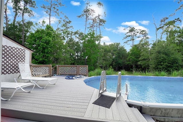 2004 Dierdorff Ct, Slidell, LA 70461 - outdoor pool featuring a wooden deck and view of wooded area